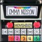 Shows an example desk nameplate with the name "Emma Nelson" on it, as well as the classroom calendar from the watercolor classroom theme decor bundle.