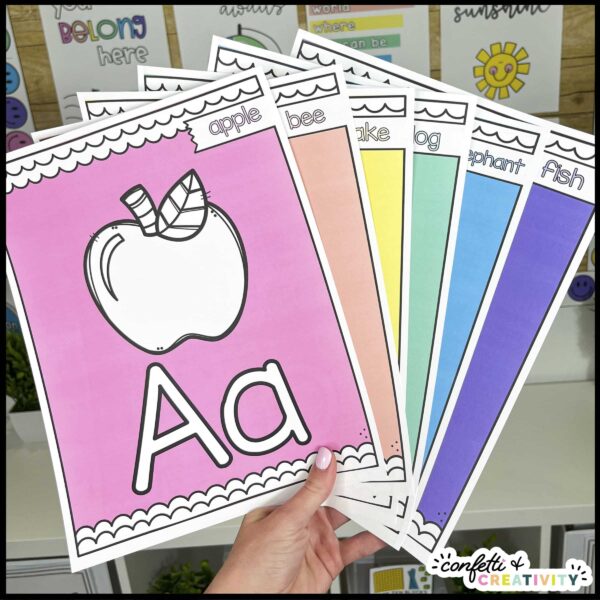 Bright and Simple Alphabet with Pictures - Real Classroom Shows multiple bright and simple classroom theme alphabet posters with pictures on them. The front picture is an apple