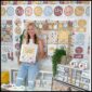 Shows the entire classroom decorated in the modern neutral classroom theme. Megan is in the middle of the room holding a binder decorated with the neutral binder cover. She's wearing a white tank top that fits with the color scheme of the neutral classroom
