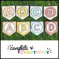 Shows two different designs for the modern neutral alphabet banner. They're laid on a grass panel to show the neutral color palette