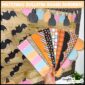 Shows the printable bulletin board borders fanned out in front of the Halloween bulletin board in the background