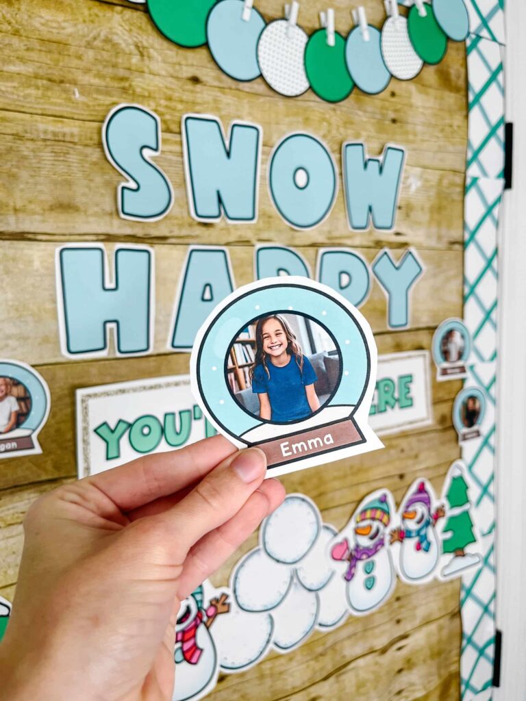 Shows an example of the snow globes that teachers can put studnet pictures into. In the background is the Winter Classroom Door Decor set up