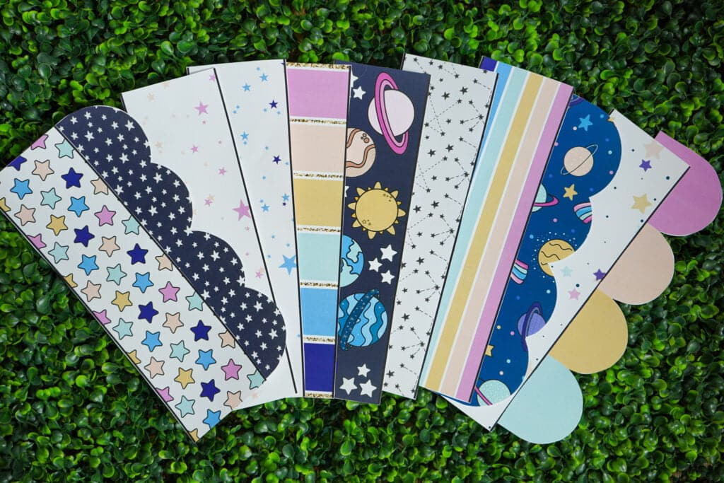 Shows fanned out bulletin board borders on a grass panel