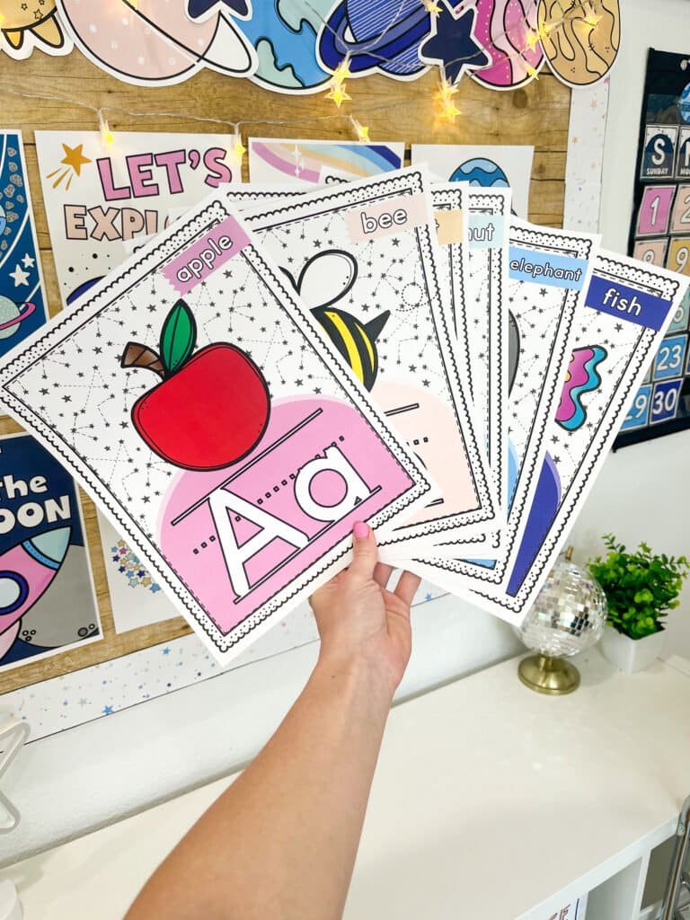 Shows fanned out space alphabet posters with pictures