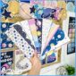 Shows the borders being held by Megan with the space classroom decor bundle in the background