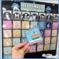 Shows the classroom calendar in a black pocket chart, while holding a holiday card for a birthday