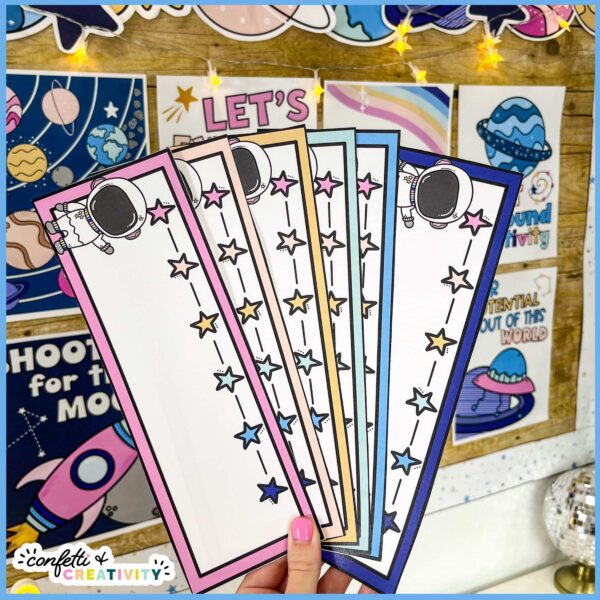 Space Desk Name Plates 2 Shows multiple student desk name plates fanned out. Each one has an astronaut on it and it comes 6 different color options