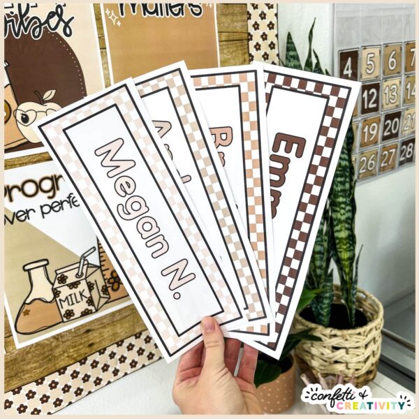 Neutral Desk Nameplates - Fanned out Examples Shows Megan holding multiple neutral desk nameplates with the name Megan on them