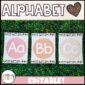Shows the alphabet posters from the boho neutral classroom theme set up on a green grass panel. Features light pinks, oranges, and tans to help a teacher set up a neutral classroom vibe