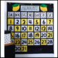 Shows Lemon Classroom Calendar lemon-themed classroom calendar features alternating yellow and white number cards, coordinating perfectly with the bold black-and-white weekday labels for a cheerful, organized display.